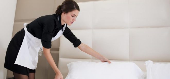 hotel-maid-making-white-bed-660x306